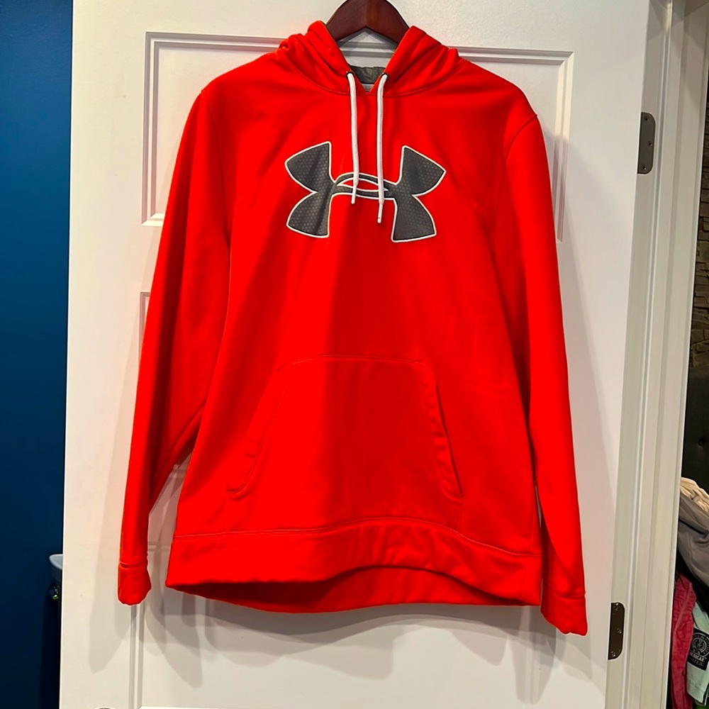 A loose fitting Under Armour Bright orange mens sweatshirt